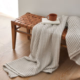 The all-weather blanket is covered in a beige color with soft camel undertones. Add a dimensional texture to your modern home décor with this perfectly pretty warm-season blanket for comfort.