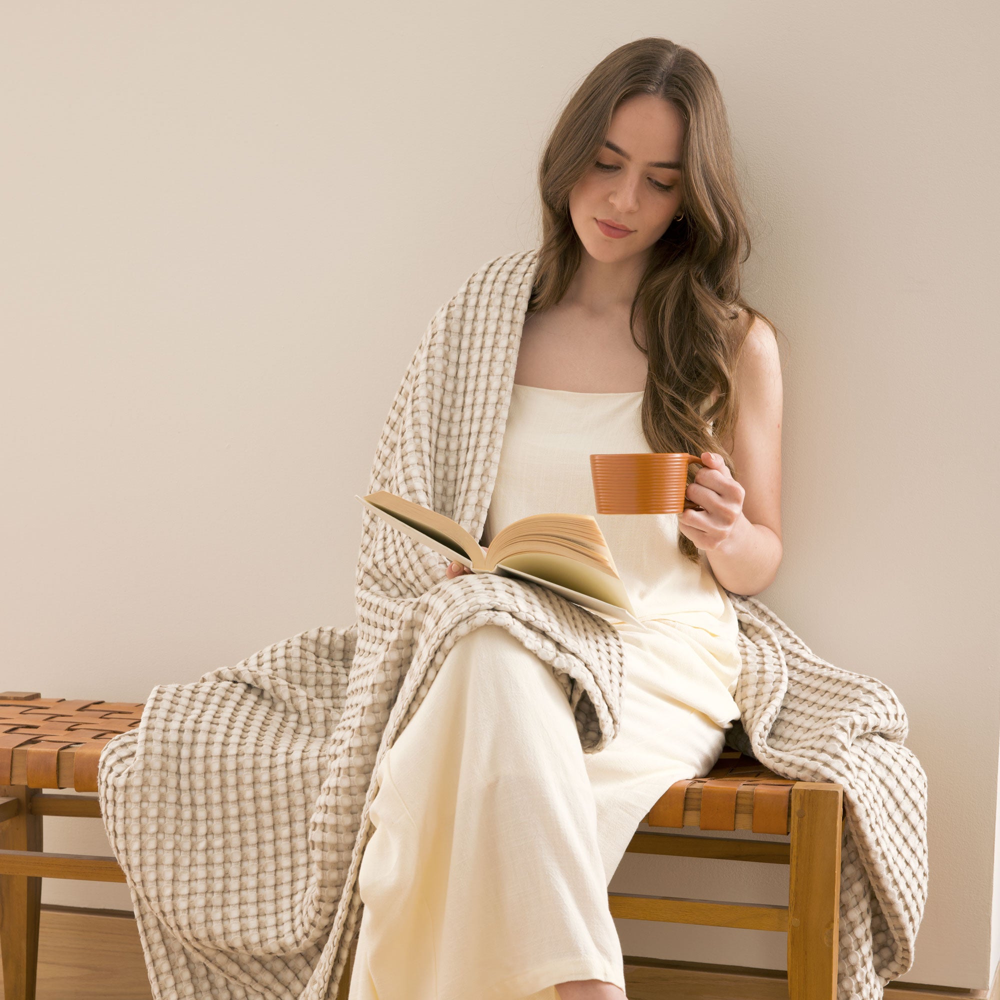 The all-weather blanket is covered in a beige color with soft camel undertones. Add a dimensional texture to your modern home décor with this perfectly pretty warm-season blanket for comfort.
