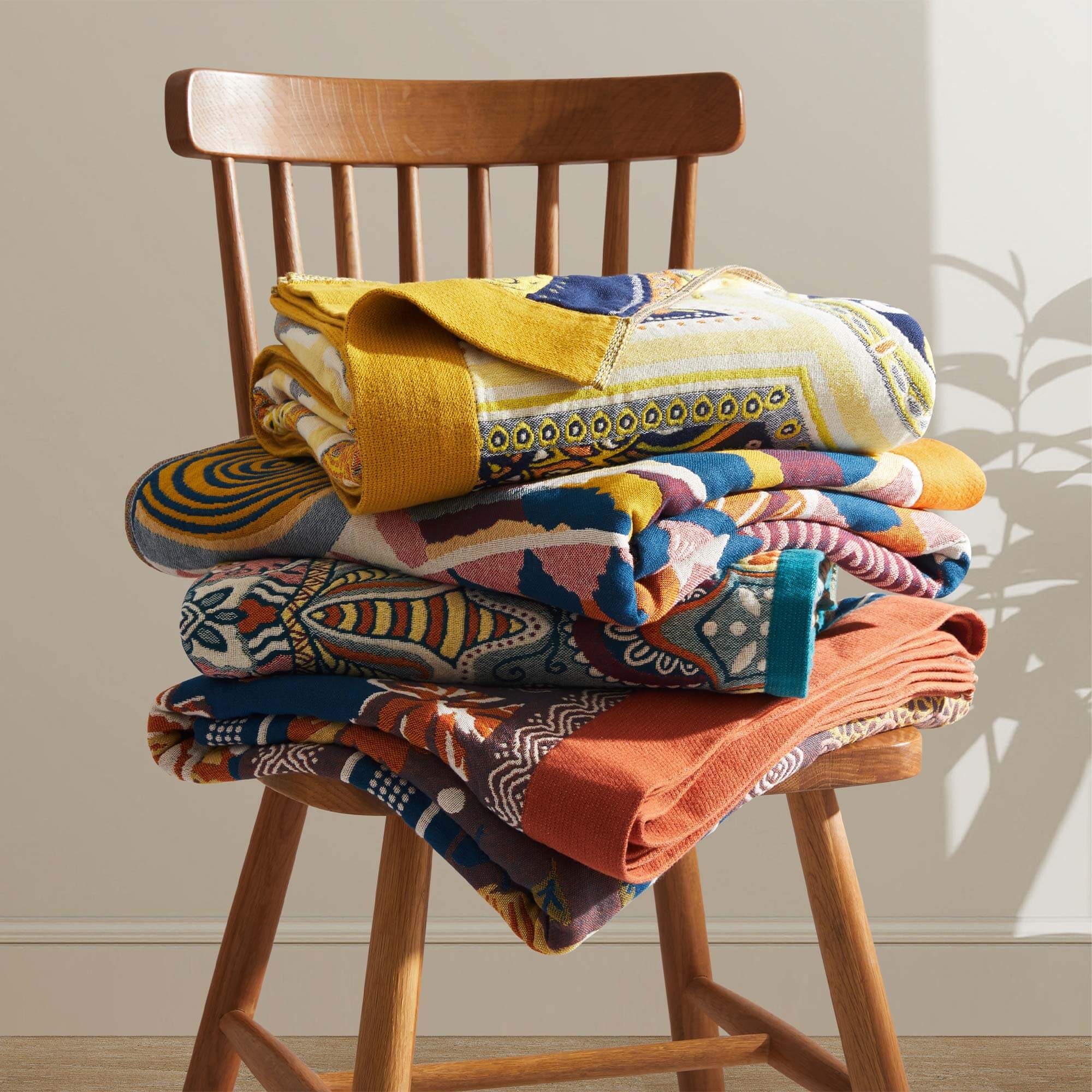 The couch blanket features abstract patterns of sunrise in vivid hues. Welcome the bright and shiny summers with this sweet blanket in Sunrise style.