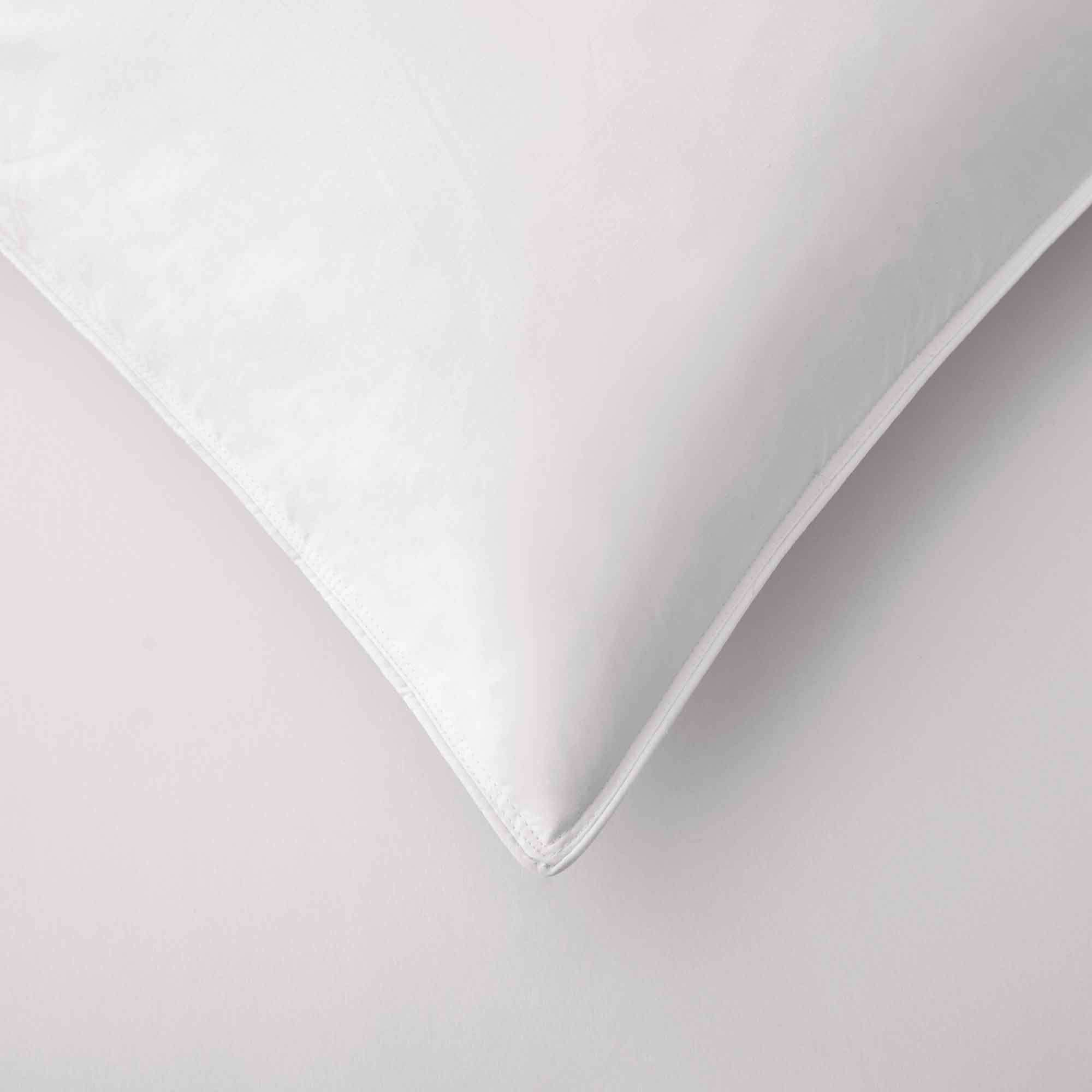 The plush pillow design is colored in the harmonious tones of white. Add a welcoming feel and luxurious comfort to your bedroom space with these overstuffed feather pillows.