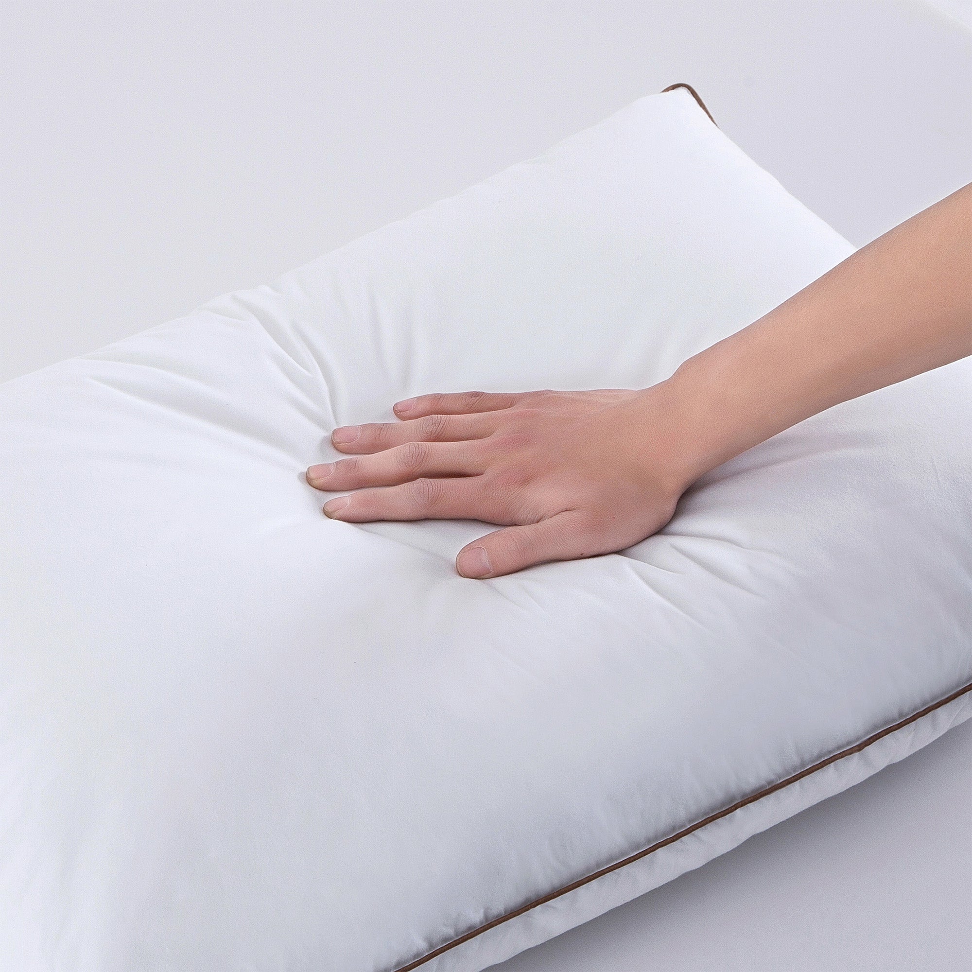 The Puredown down plush pillow is colored in soft tones of white. Bring a sense of minimalism to your bedroom space with these goose feather pillows.