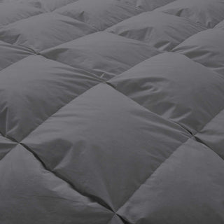 The goose down comforter is enveloped in smoky grey tones. Add a touch of minimal style to your bedroom decor with this all-seasons comforter.