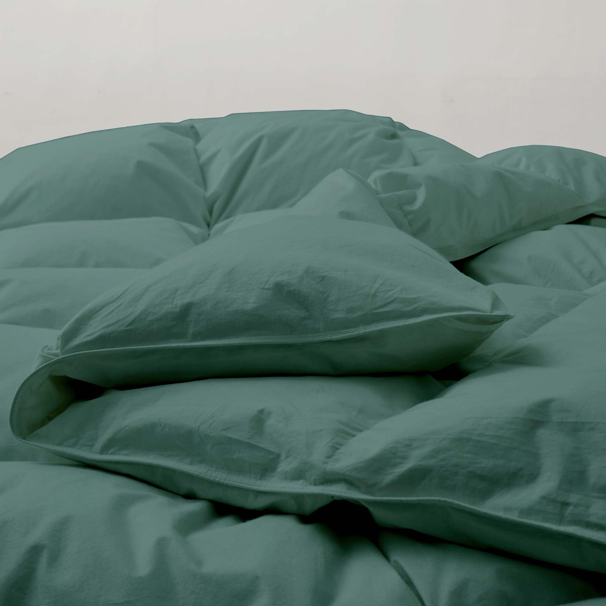 The down feather comforter is brushed in medium tones of forest green. Add a natural element to your bedroom style with this green color medium weight comforter.