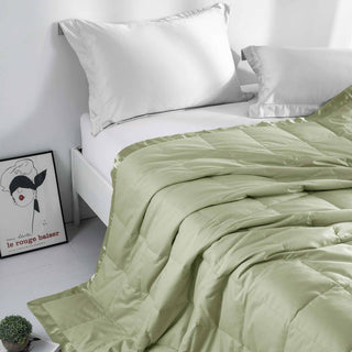The down feather blanket with satin trim is colored in the soft tones of pale green. Bask in the tranquility of nature with the oversized bed blanket in Pale Green.